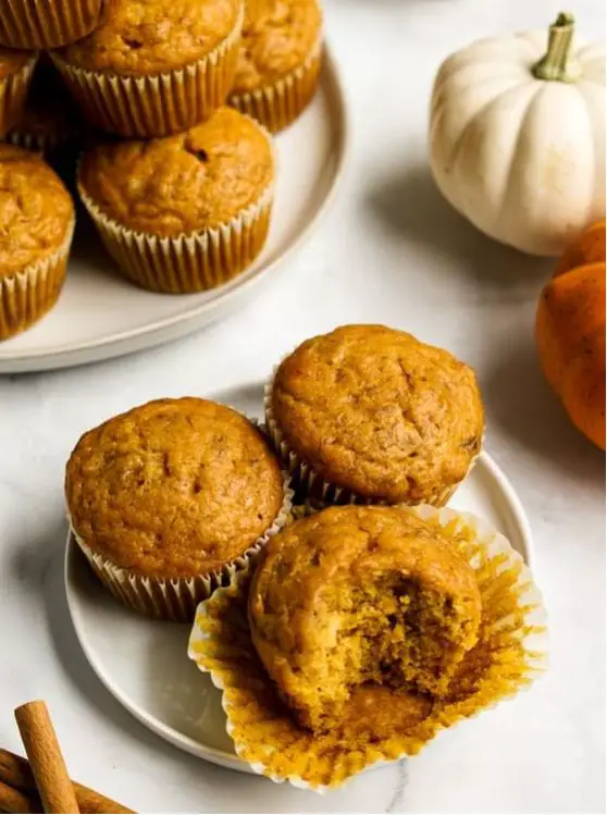Freshly baked pumpkin banana muffins cooling on a wire rack.