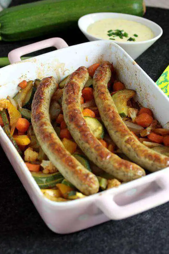Grilled bratwurst sausages on a barbecue, highlighting Bratwurst Calories as discussed in the article